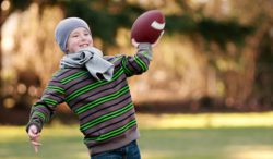 Young boy throwing football