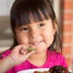 child eating vegetables