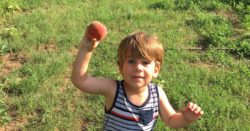 boy picking a peach in Oklahoma